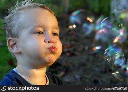 Close-up of a boy blowing bubbles