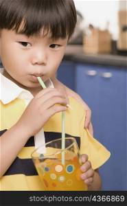 Close-up of a boy drinking juice