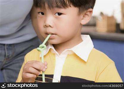 Close-up of a boy drinking with a straw