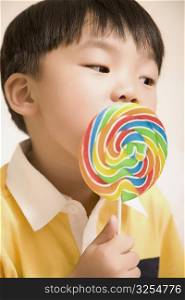 Close-up of a boy eating a lollipop