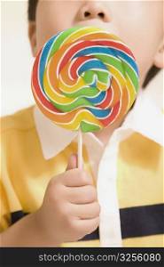 Close-up of a boy eating a lollipop