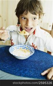 Close-up of a boy eating corn flakes