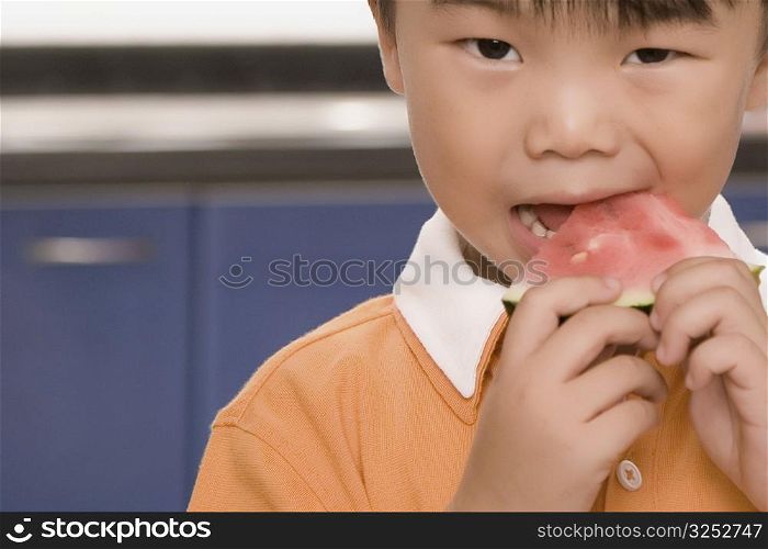 Close-up of a boy eating watermelon