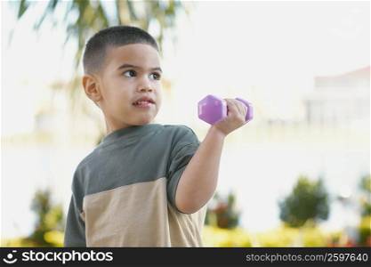 Close-up of a boy exercising with dumbbells