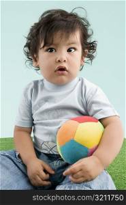 Close-up of a boy holding a ball