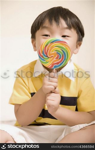 Close-up of a boy holding a candy