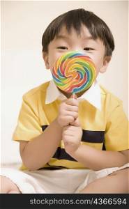 Close-up of a boy holding a candy