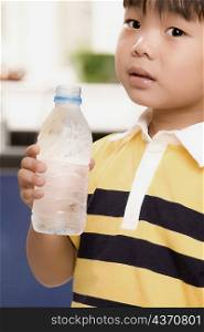 Close-up of a boy holding a water bottle