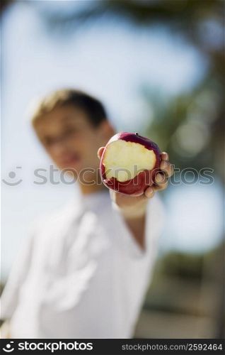 Close-up of a boy holding an apple