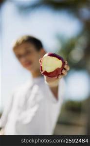 Close-up of a boy holding an apple