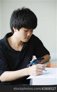 Close-up of a boy holding calculator