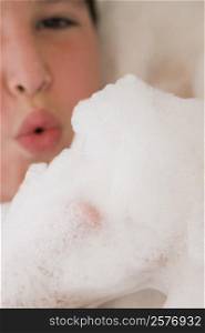 Close-up of a boy in a bubble bath