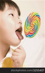 Close-up of a boy licking a lollipop