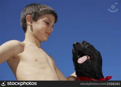 Close-up of a boy looking at a dog