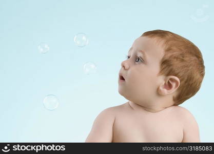 Close-up of a boy looking at bubbles
