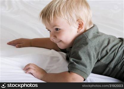 Close-up of a boy lying down on a bed