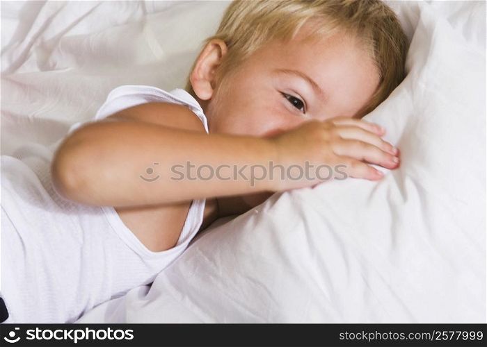 Close-up of a boy lying on the bed