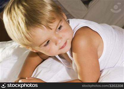 Close-up of a boy lying on the bed