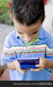 Close-up of a boy playing a handheld video game