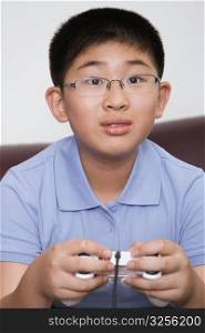 Close-up of a boy playing video game