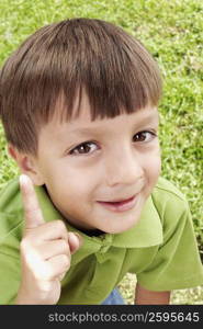 Close-up of a boy pointing and smiling