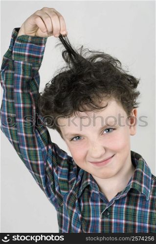Close-up of a boy pulling his hair