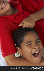 Close-up of a boy pulling the hair of another boy