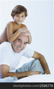 Close-up of a boy riding piggyback on his father