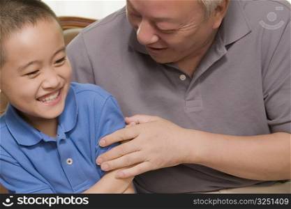 Close-up of a boy smiling with his grandfather