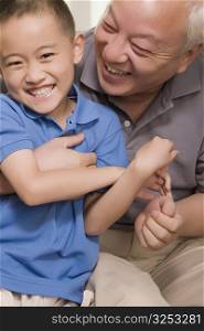 Close-up of a boy smiling with his grandfather