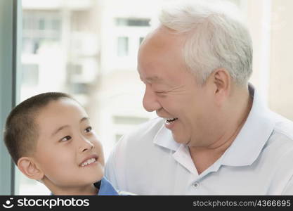 Close-up of a boy smiling with his grandfather