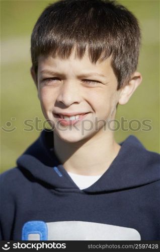 Close-up of a boy smirking