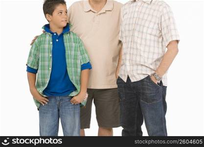Close-up of a boy standing with his father and grandfather