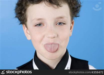 Close-up of a boy sticking its tongue out