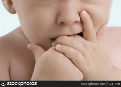 Close-up of a boy sucking his fingers