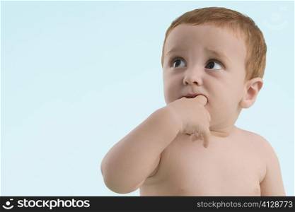 Close-up of a boy sucking his fingers