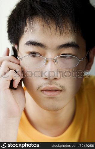 Close-up of a boy talking on mobile phone