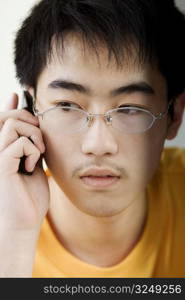 Close-up of a boy talking on mobile phone