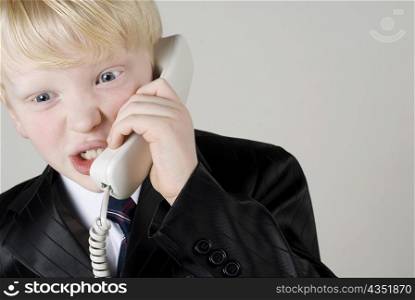 Close-up of a boy talking on the telephone