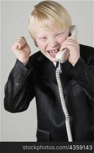 Close-up of a boy talking on the telephone