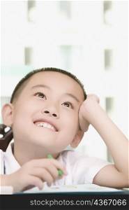 Close-up of a boy thinking and smiling