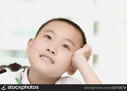 Close-up of a boy thinking and smiling