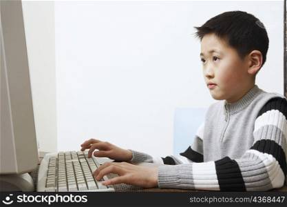Close-up of a boy using a computer