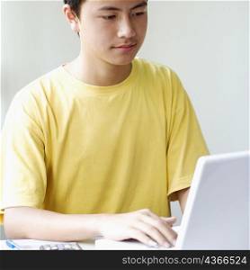 Close-up of a boy using a laptop