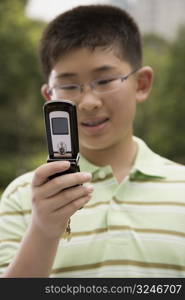 Close-up of a boy using a mobile phone