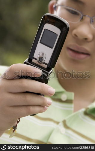 Close-up of a boy using a mobile phone