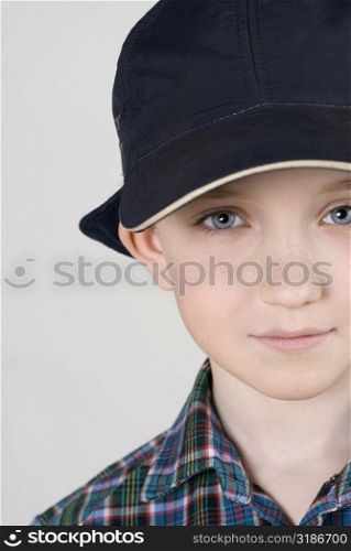 Close-up of a boy wearing a cap