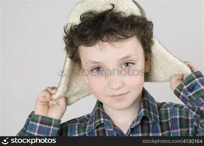 Close-up of a boy wearing a fur hat