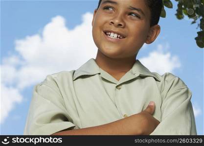 Close-up of a boy with his arms crossed