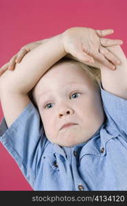 Close-up of a boy with his arms crossed